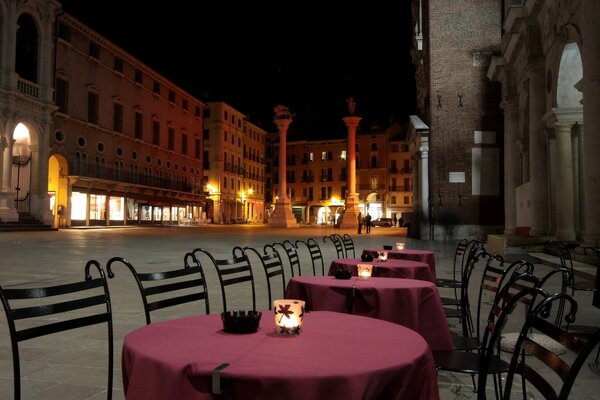 Cafe in Venice at night. The atmosphere of a European city in the evening