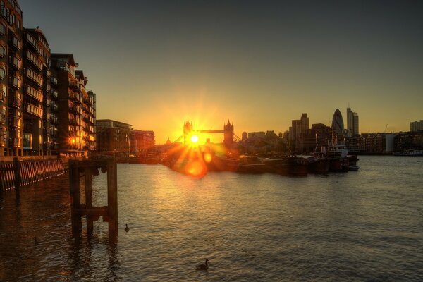 The sunset is beautiful over the water in the city of Europe (probably in Venice)