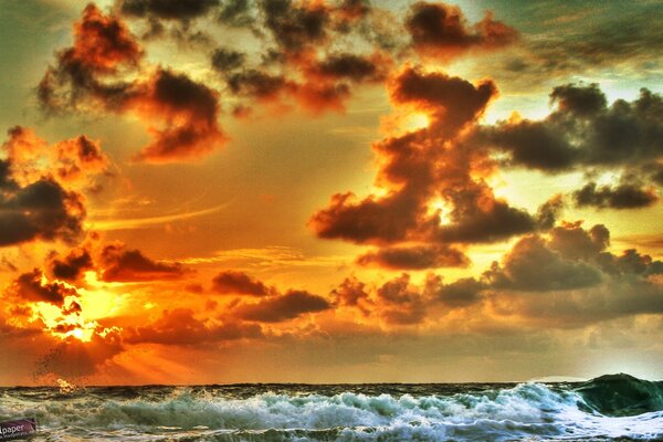 Orange sunset over the raging sea