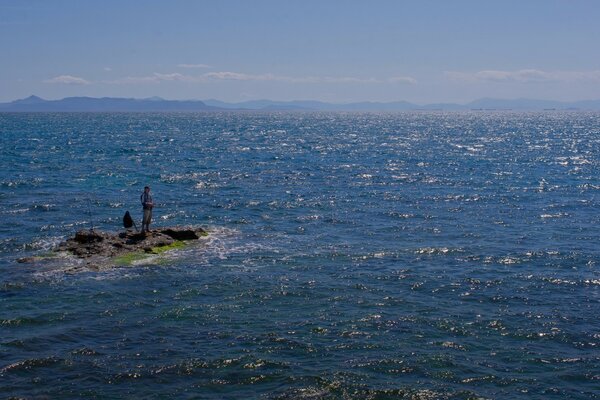 A miniature island in the sea for a couple of fishermen