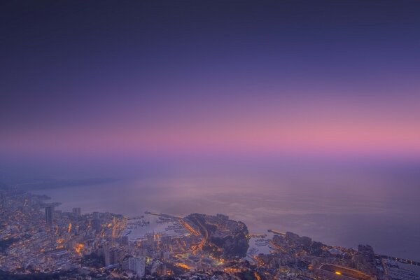 View of the city from above. Sunset and evening city