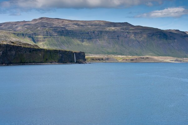 The heavenly surface of the lake on the background of the mountain