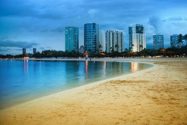 Ocean shore and night metropolis