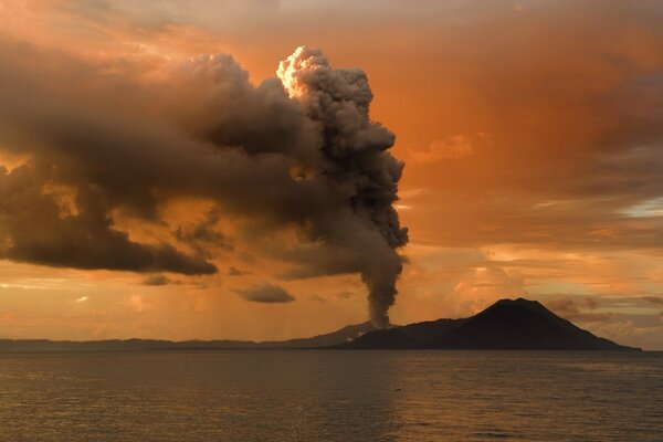 Smoking volcano on the background of dawn