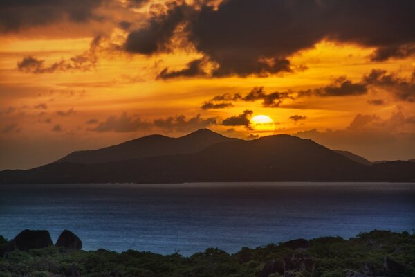 Tropical rocky island on sunset background