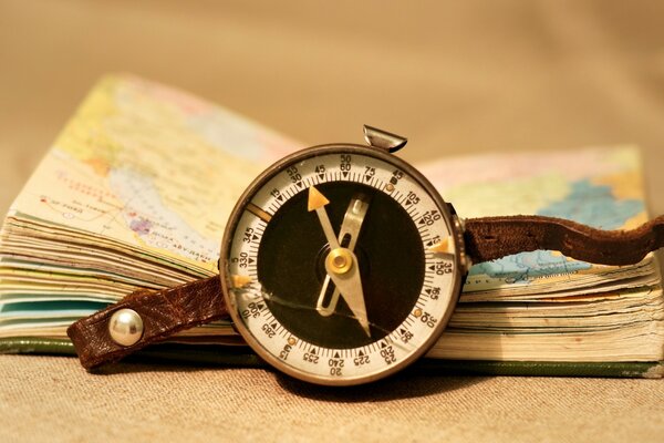 A map in a notebook and a compass