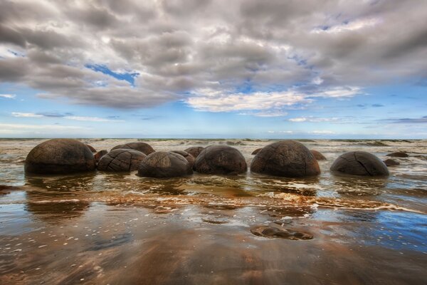 Камені лежать на пісочному пляжі