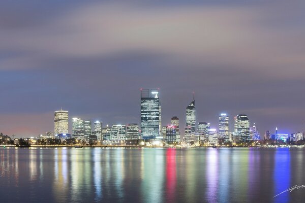 The night city reflected in the surface of the water