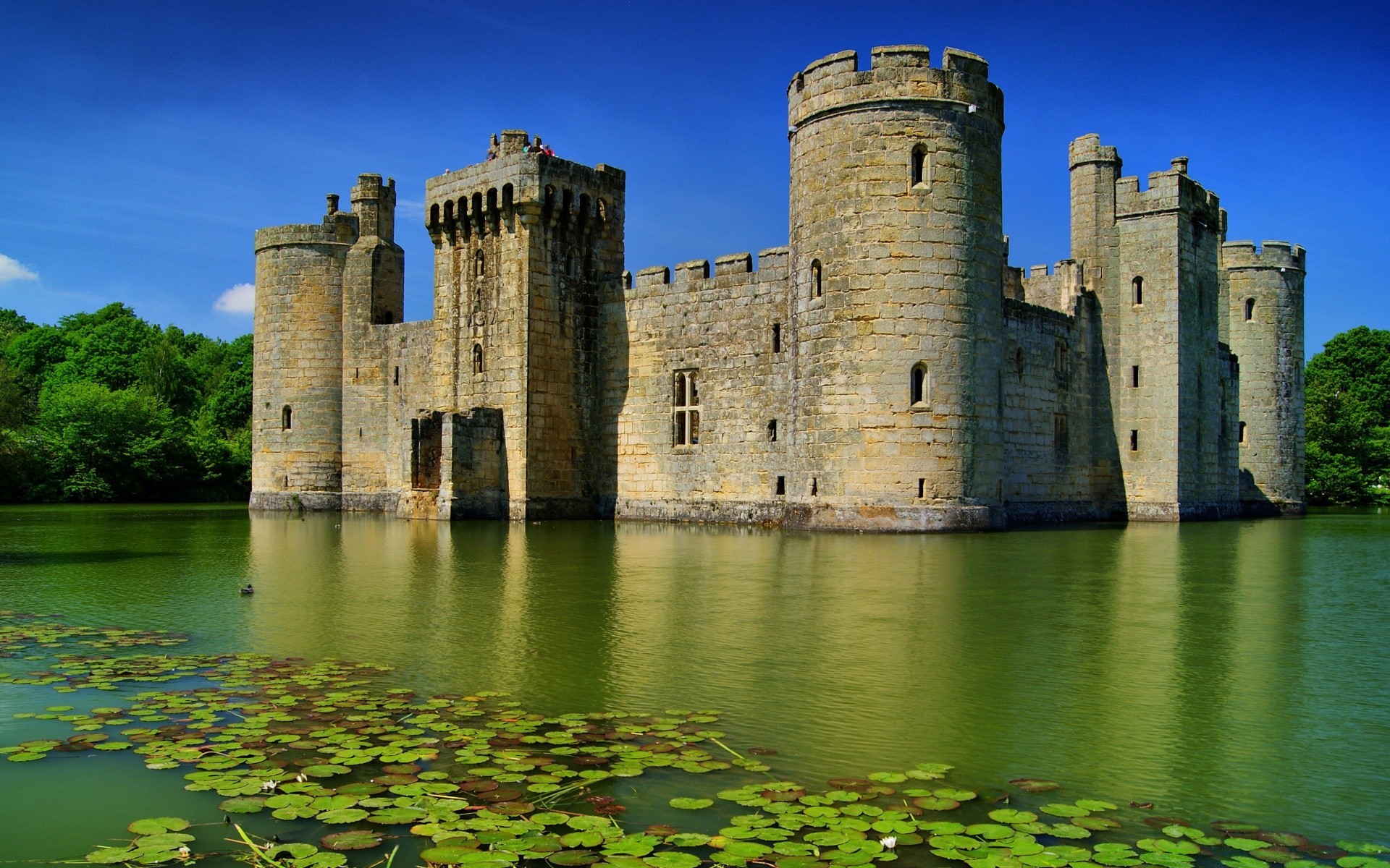 other city castle architecture gothic tower travel fortress river water ancient outdoors old landmark fortification building lake sky moat turret reflection