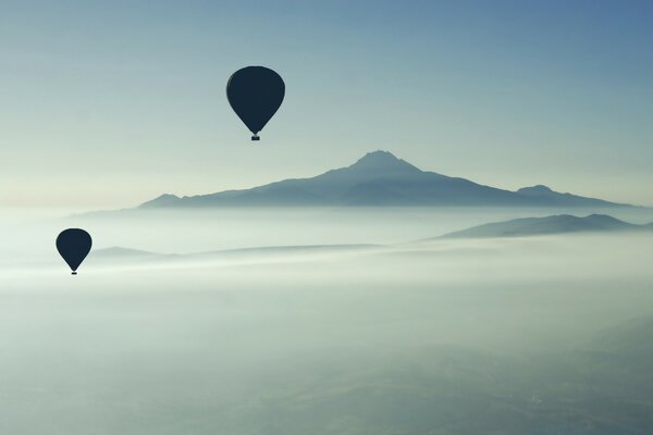 Two flying balloons in the sky