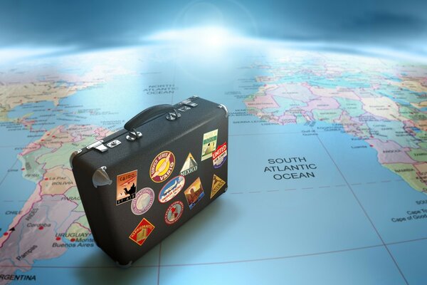 Suitcase for travel on the earth map